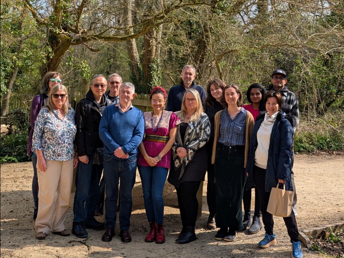 A group of our volunteers smiling posing for a photo in the sun and Bristol Zoo project.