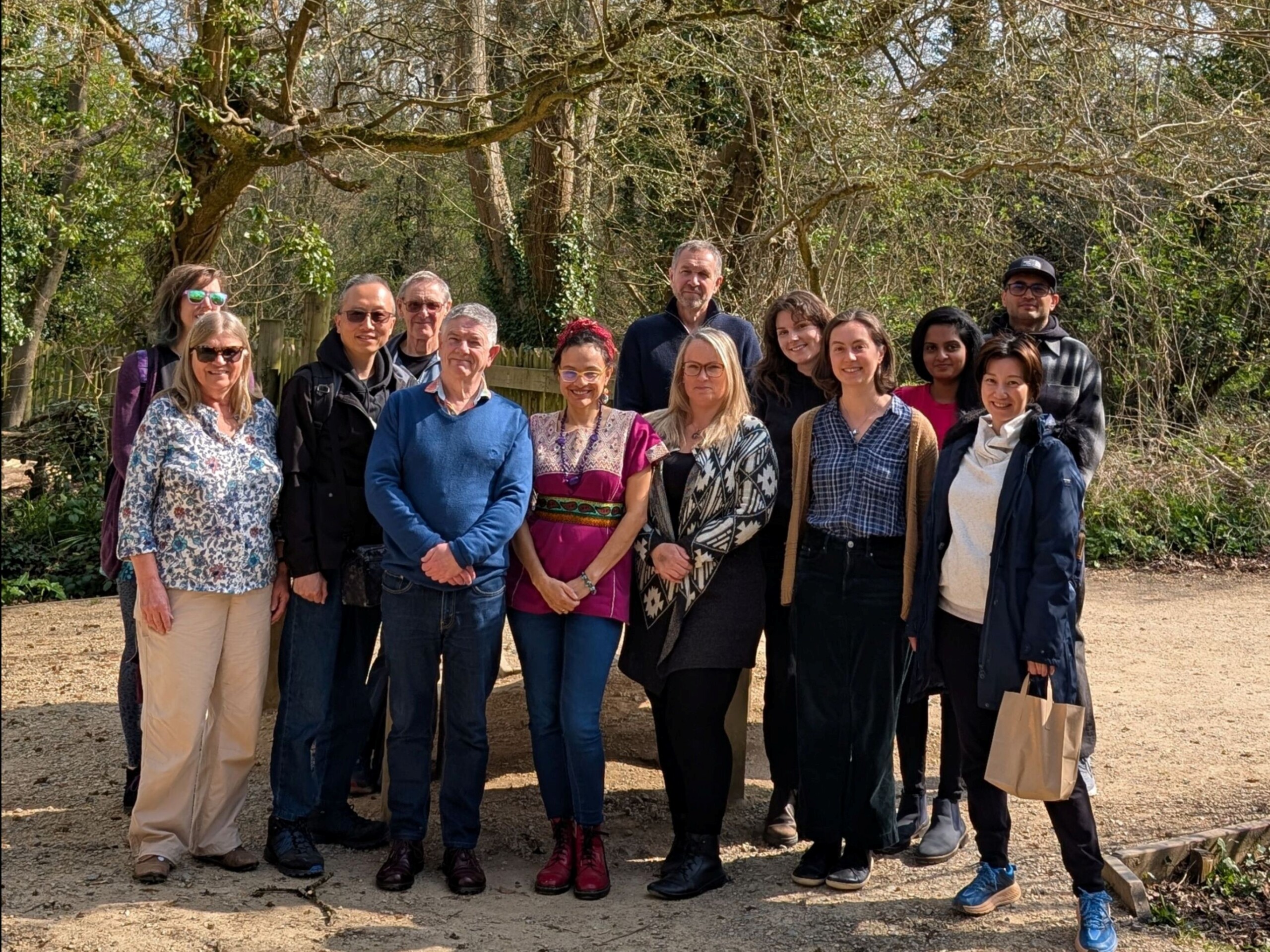 A group of our volunteers smiling posing for a photo in the sun and Bristol Zoo project.