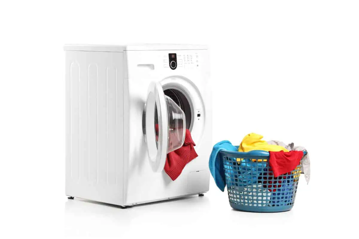 A washing machine and full laundry bin isolated on white background
