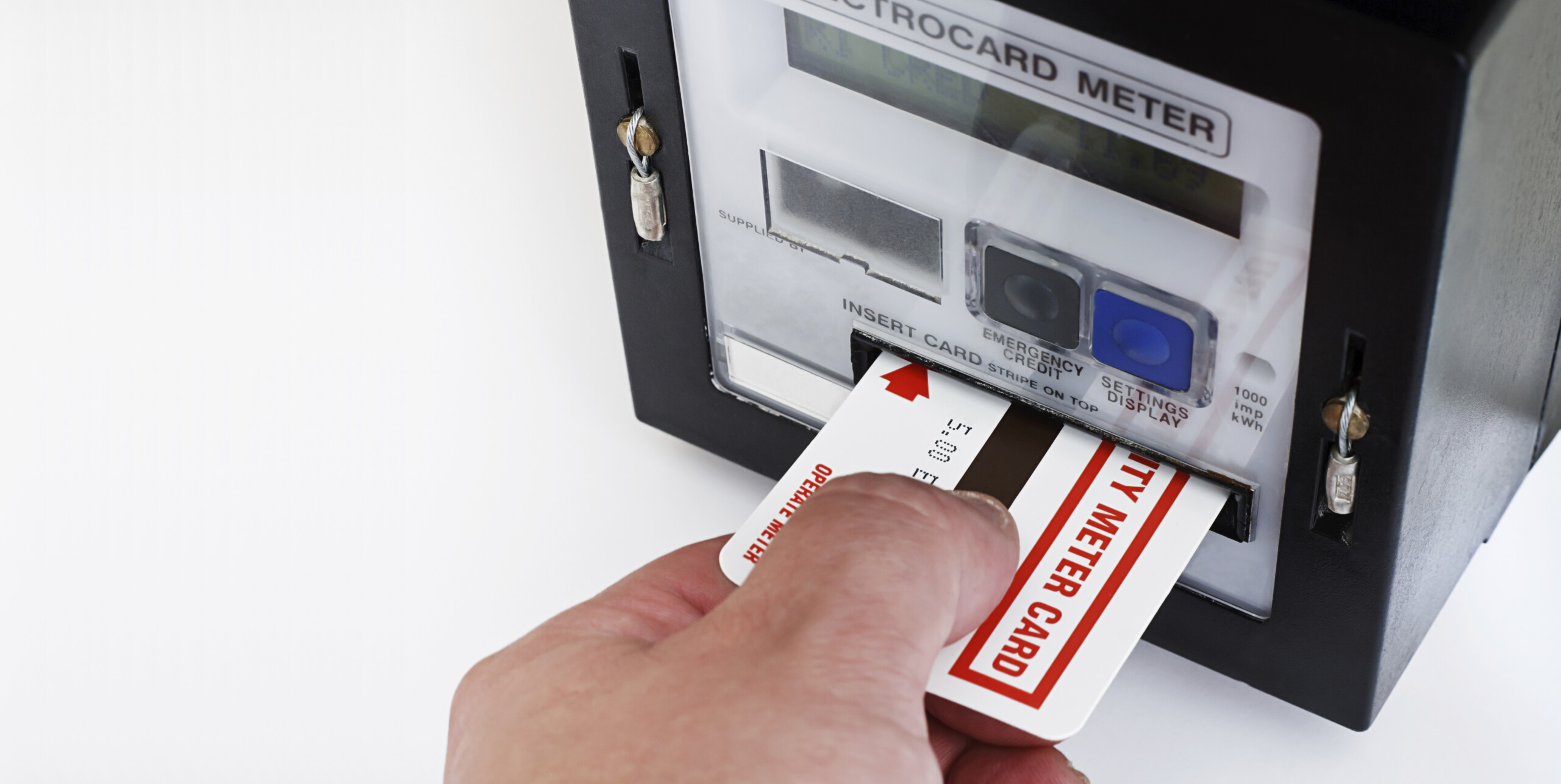 A person inserts a card into a prepayment meter