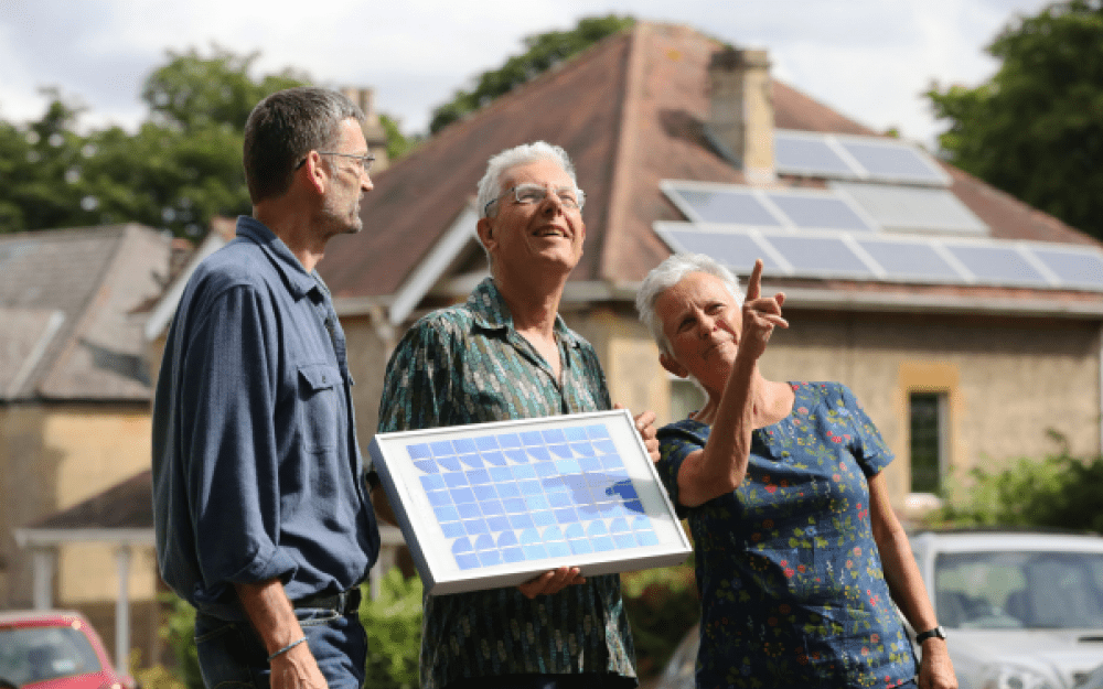 Local people hold a small solar panel