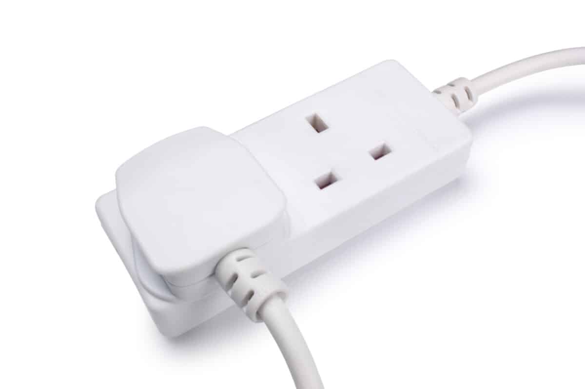 A plug for a domestic appliance connected to an extension lead.