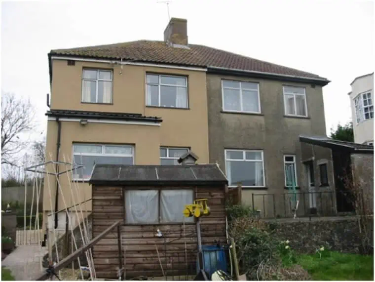 The back of two semi-detached houses, with a shed in one garden