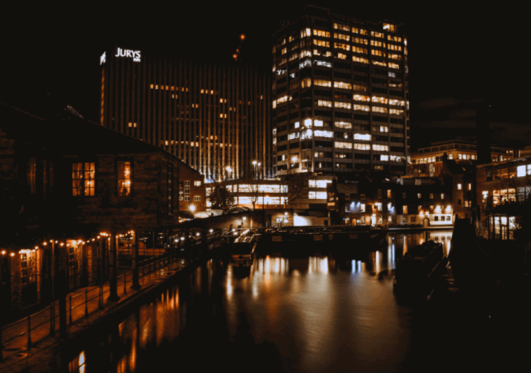 A city in the dark with lights coming from skyscrapers