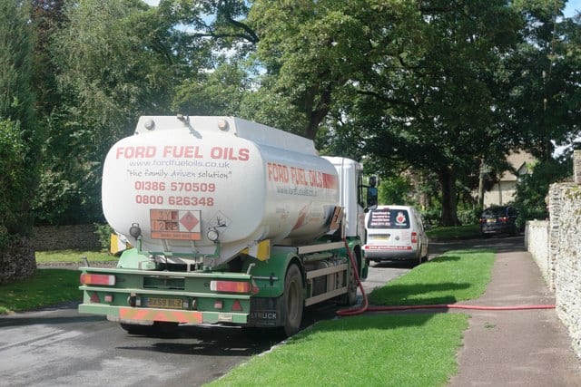A tanker lorry delivers domestic heating oil to a home in the UK