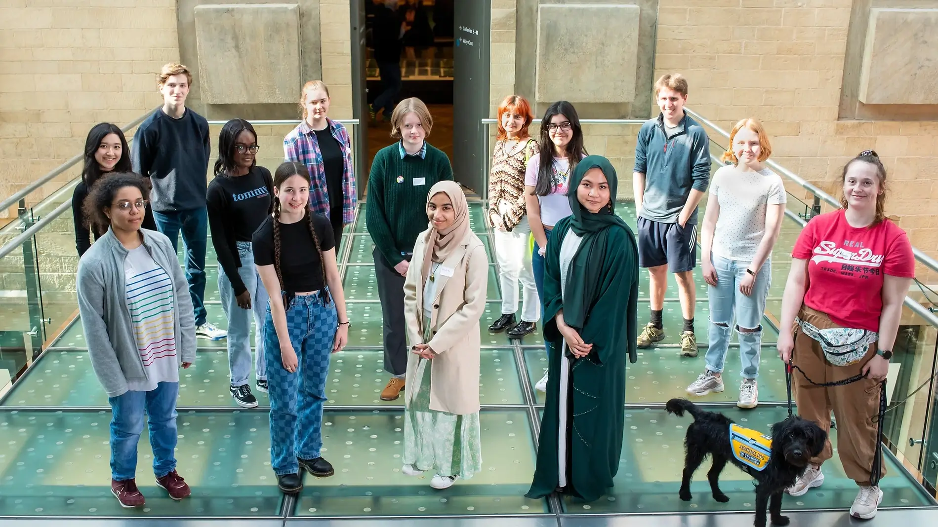 A group of 16-19 year olds who were part of the Bright Green Future Programme. 14 students stand smiling at the camera.