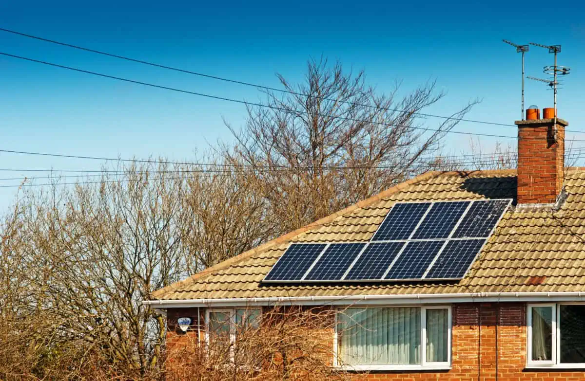 Solar panels on the roof of a house. It's winter, but the sky is bright so the panels will still be generating useful amounts of electricity.