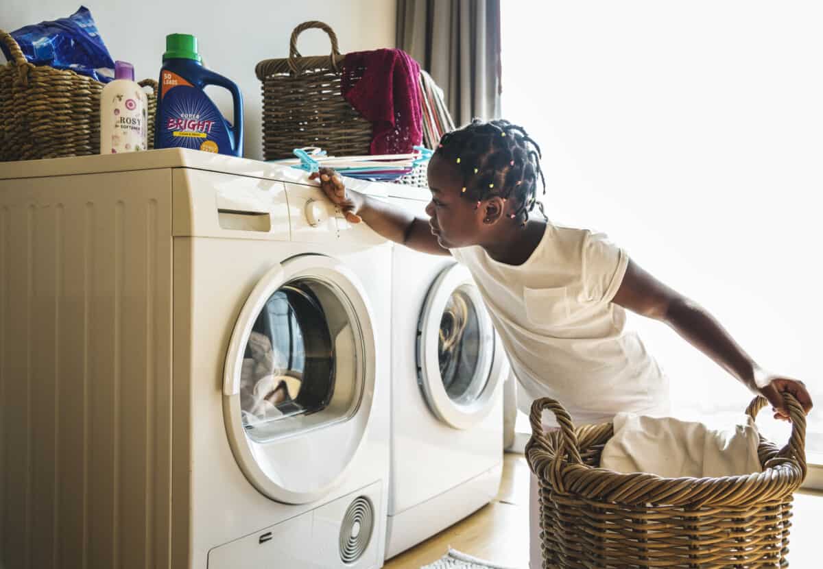 A girl doing the laundry in her home.