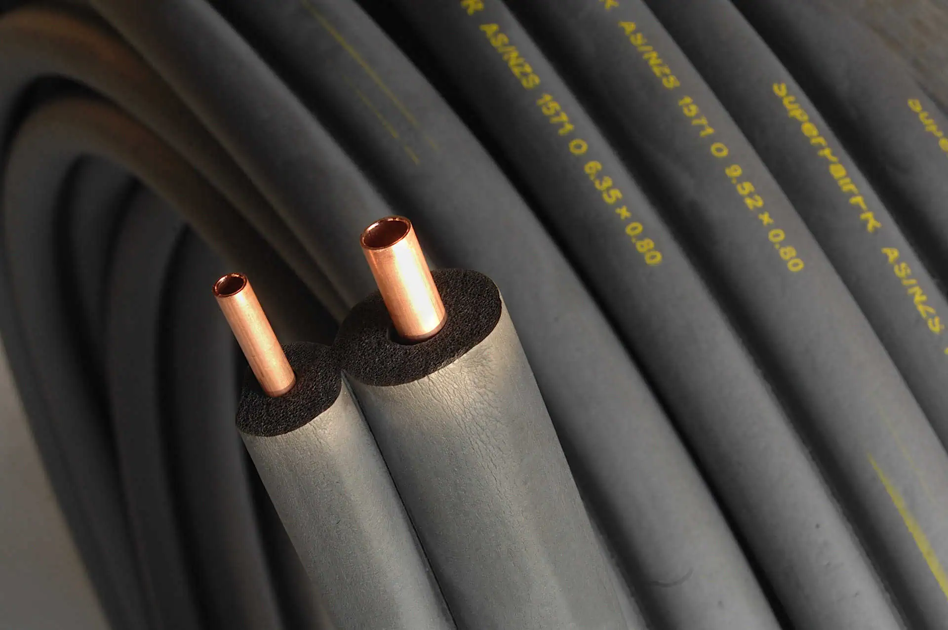 Two copper central heating pips lagged with insulating foam.