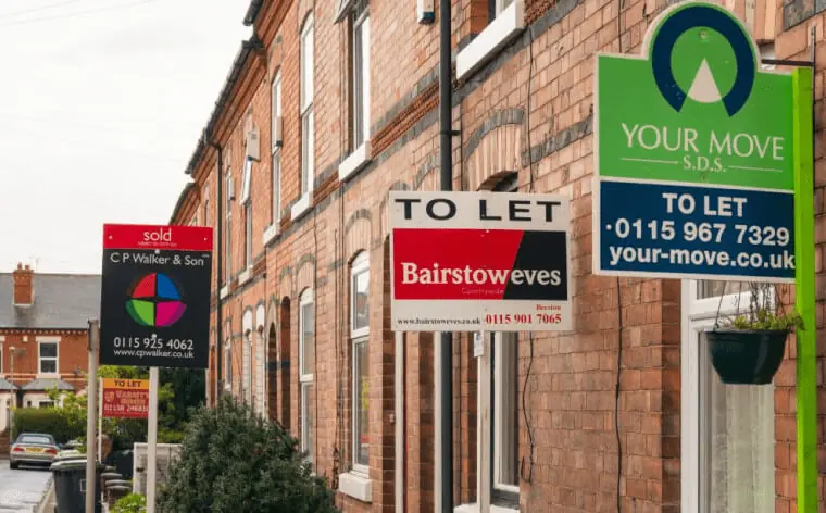 Row of terraced houses with 'to let' signs outside