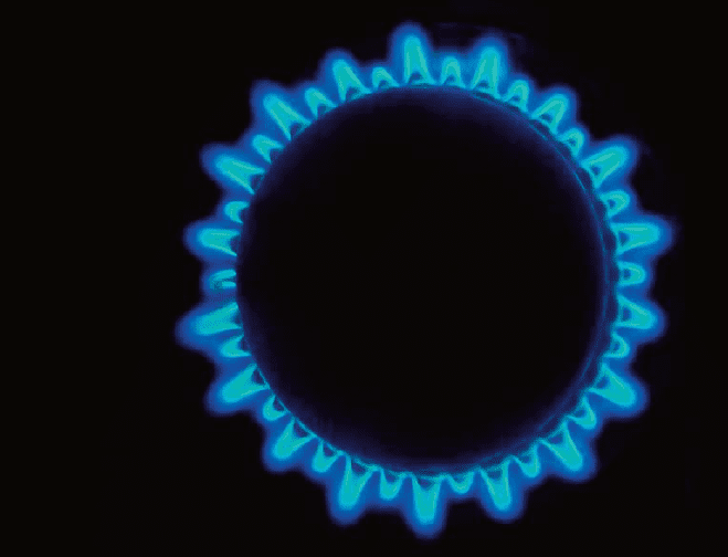 Close up from above of a circular ring of gas flame from a cooker ring
