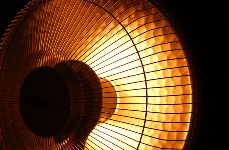 Close of of a halogen heater glowing in the dark
