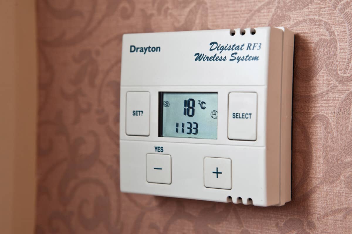 A wall mounted room thermostat