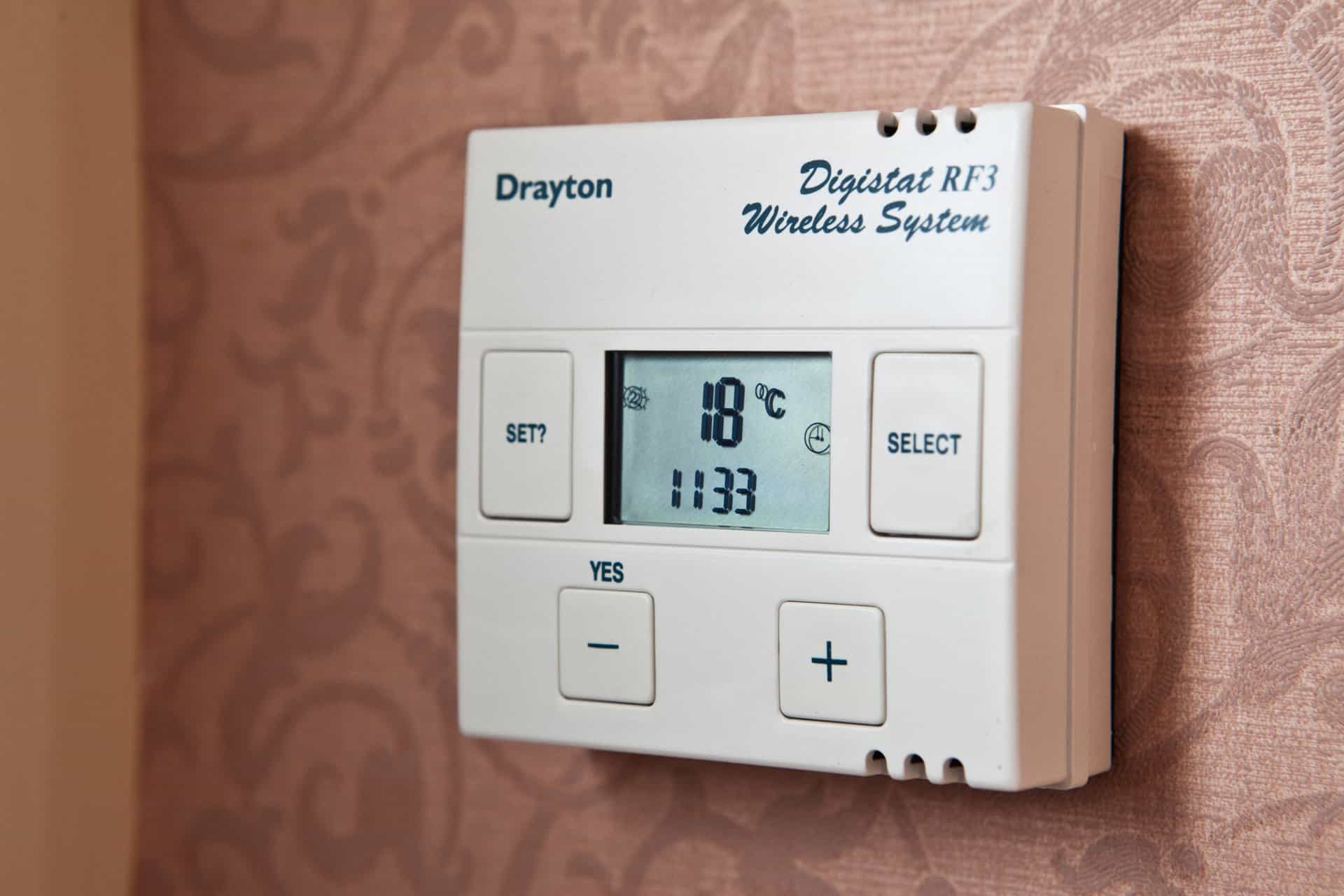 A wall mounted room thermostat