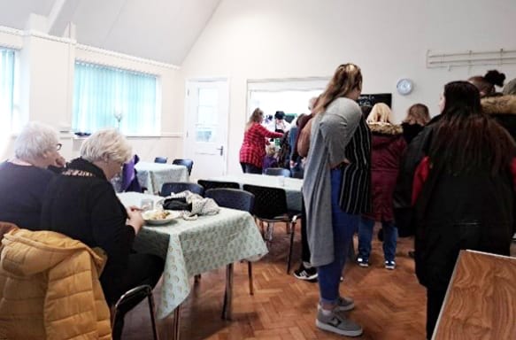 People at a community centre having a warm meal.