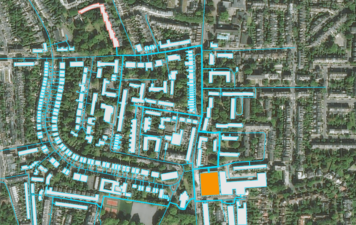 A satellite image of a town overlaid with a graphic of a network of district heating pipes.