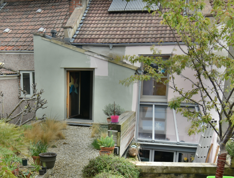The back of a terraced home that has been retrofitted with solar hot water and new windows, as well as garden improvements.