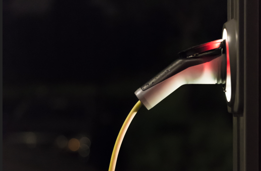 Detail of an electric car charging point at night