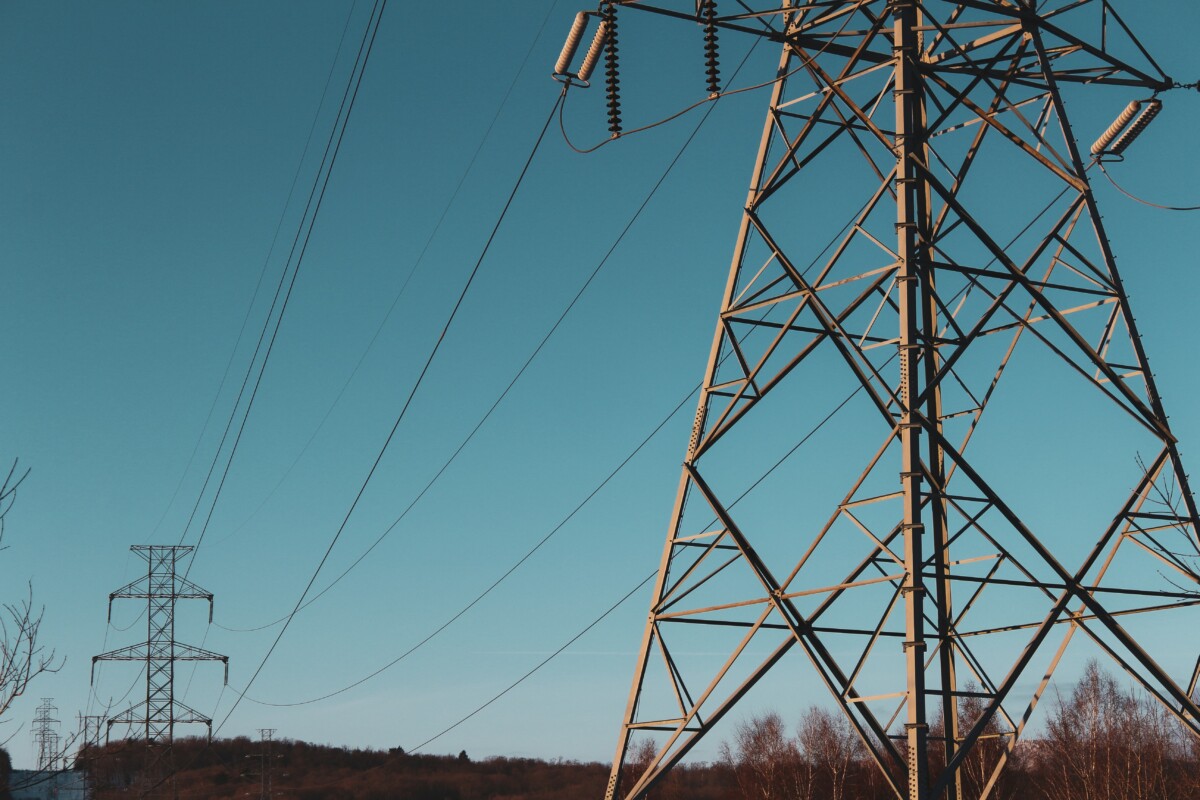 A line of electricity pylons with blue sky