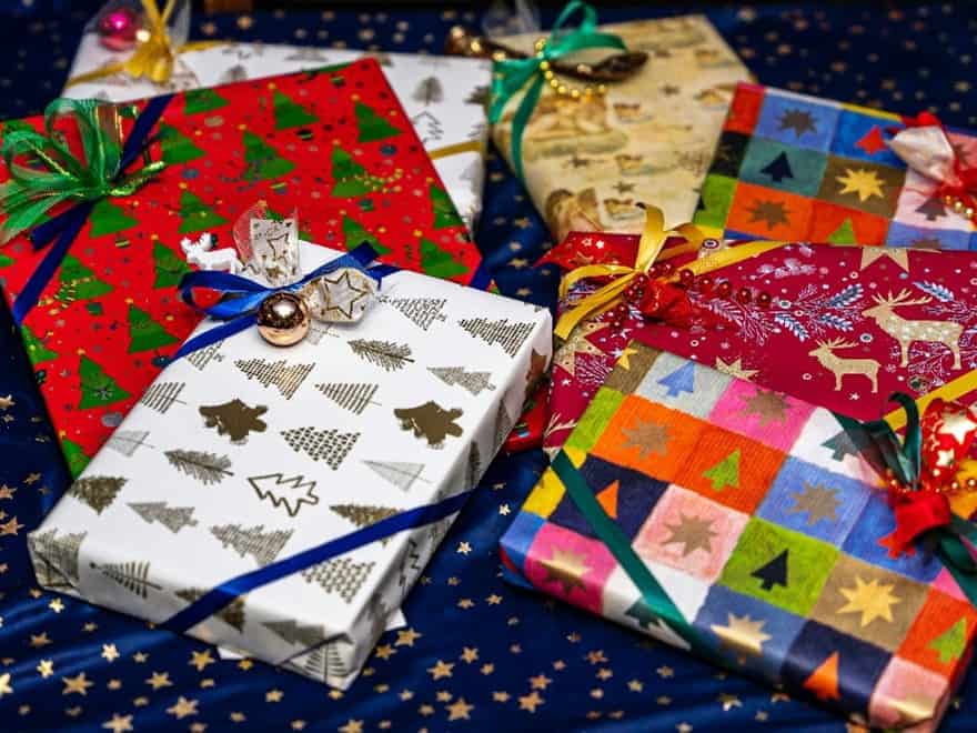 A pile of brightly coloured wrapped gift boxes.