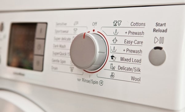 Close up shot of the controls of a washing machine.