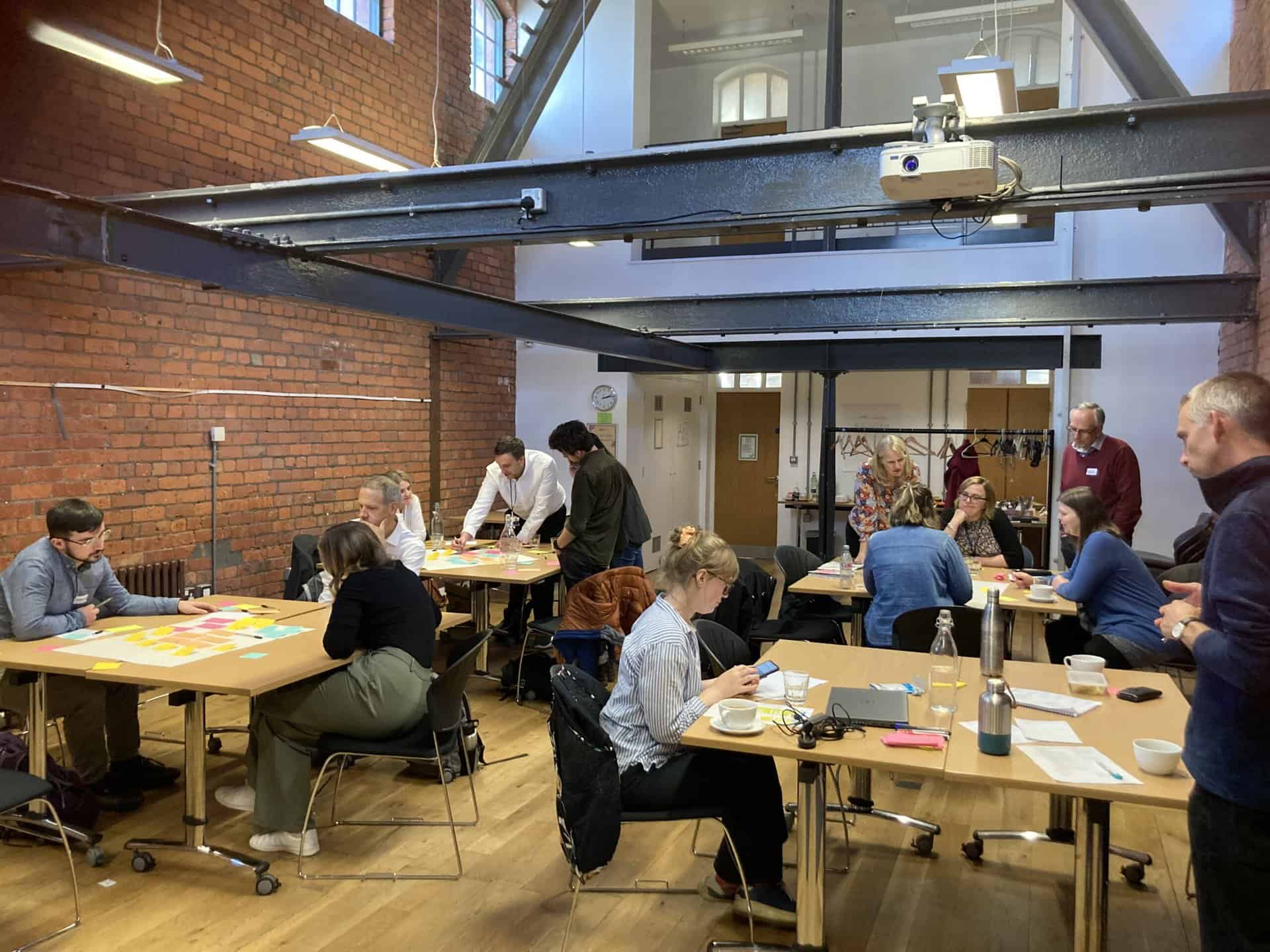 A group of people attending a workshop in a museum.