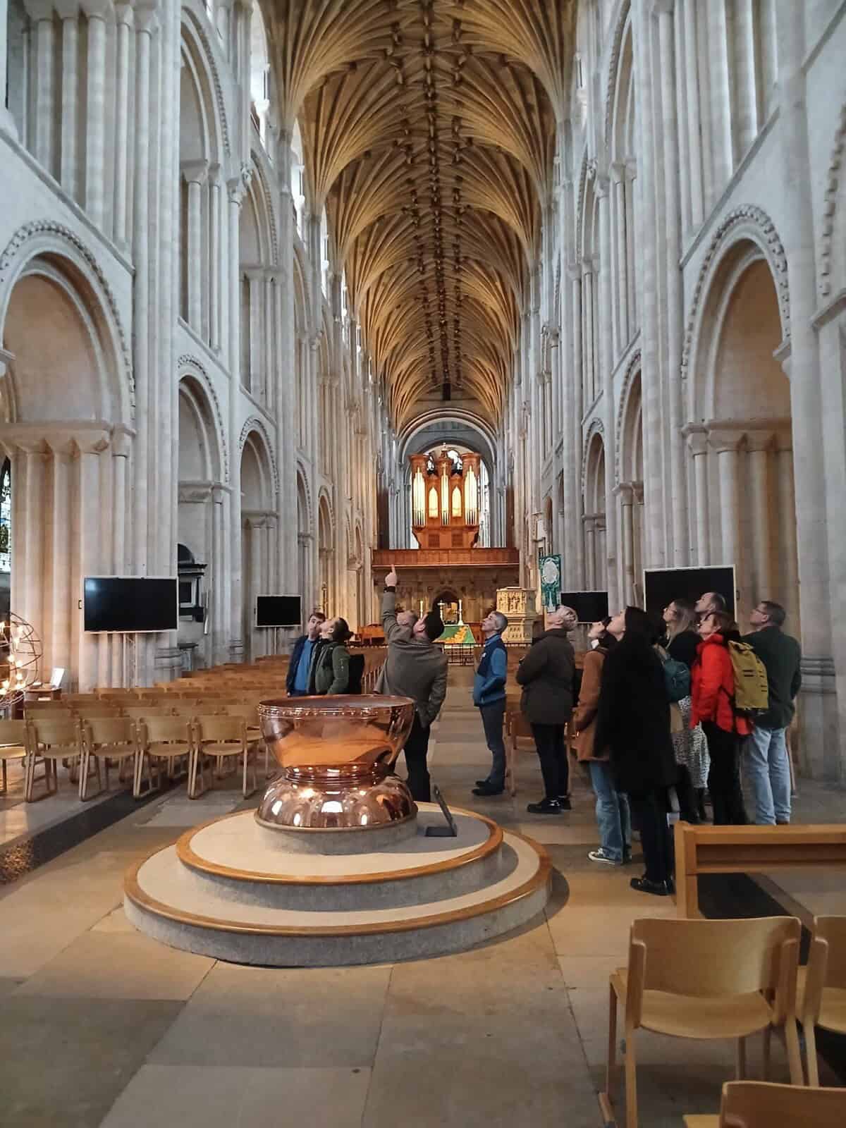 A group of people being shown around Norwich Cathedral