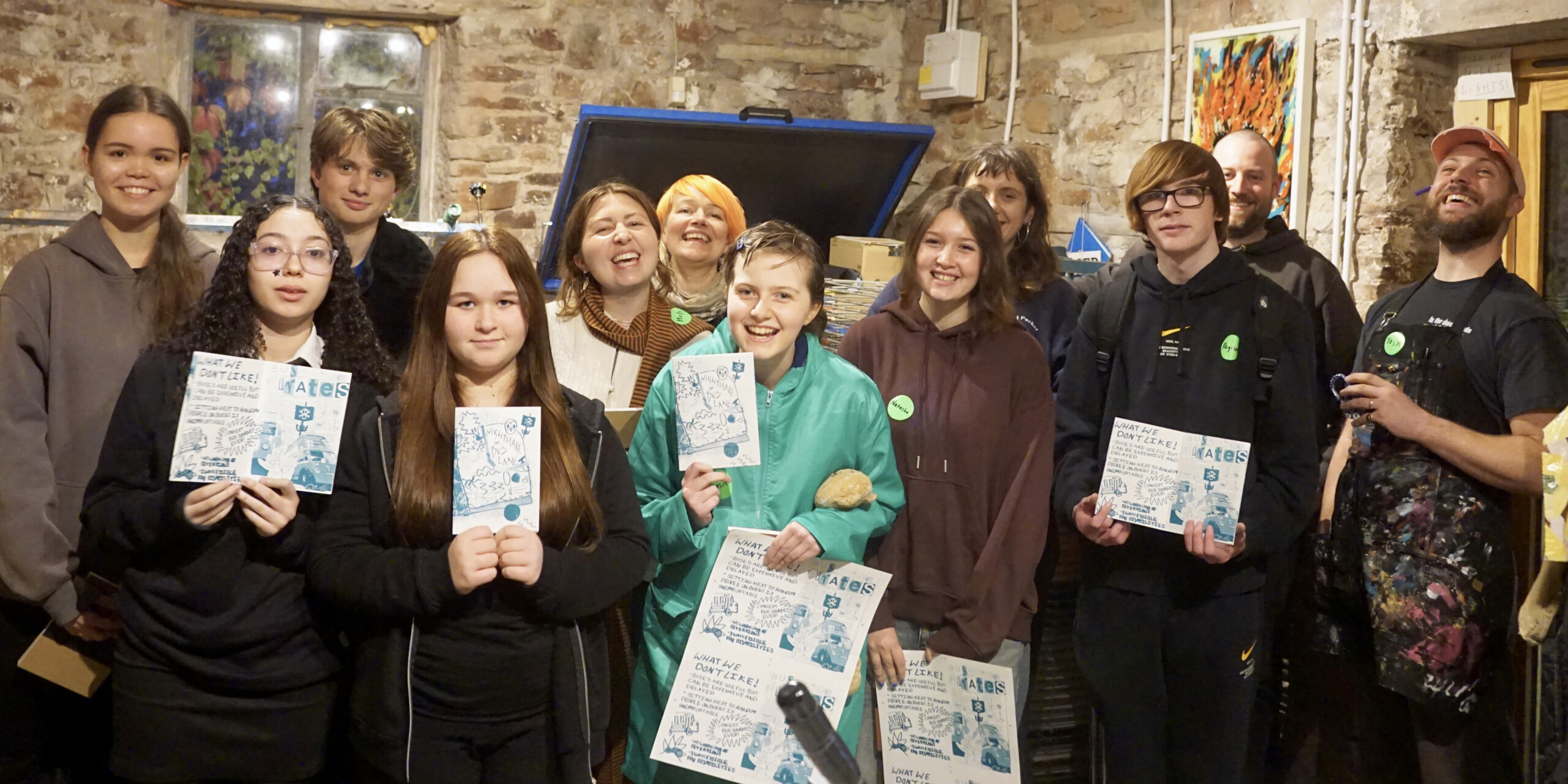 Group of young people showing zines they have made.