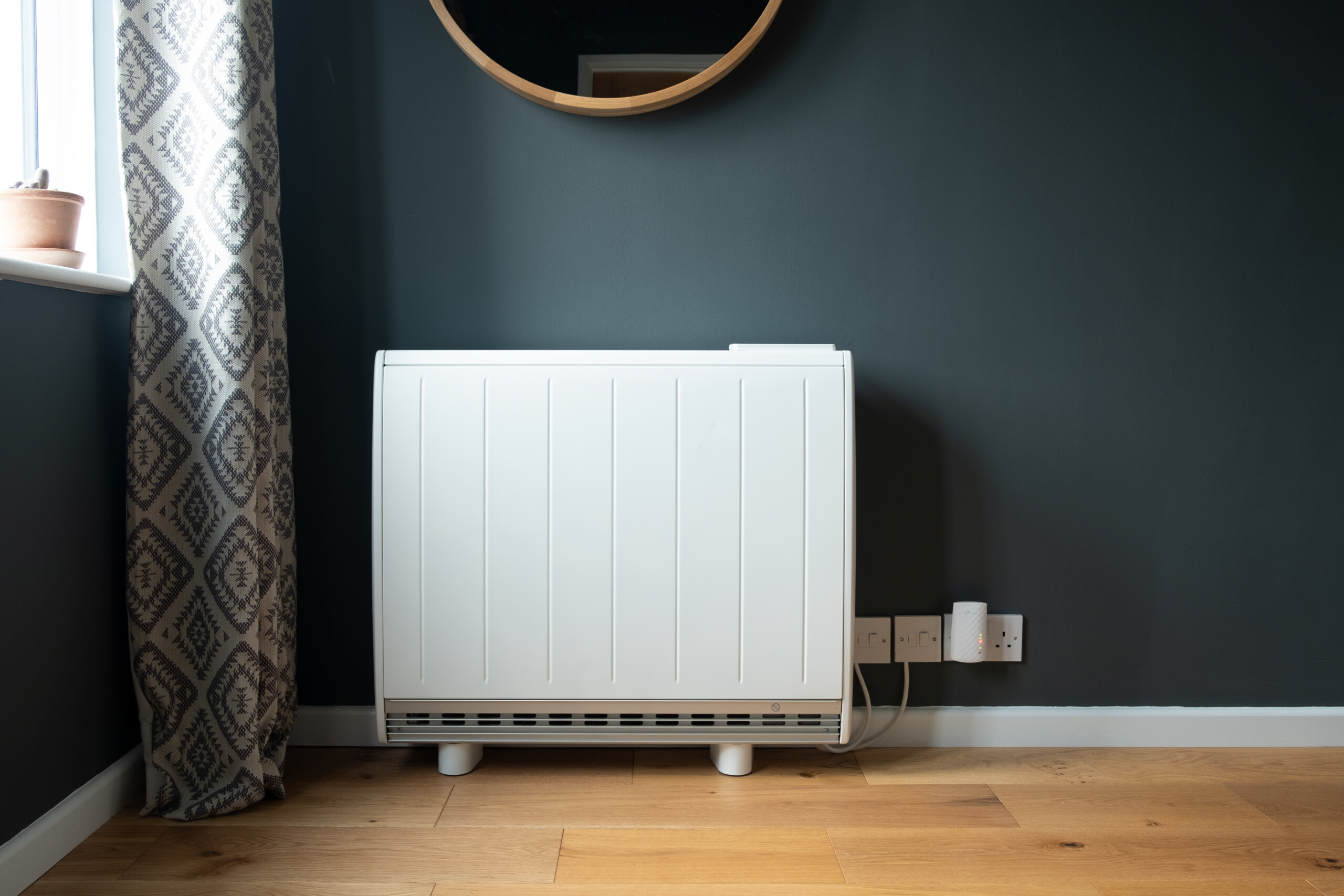 An electric radiator in a comfortable-looking room.