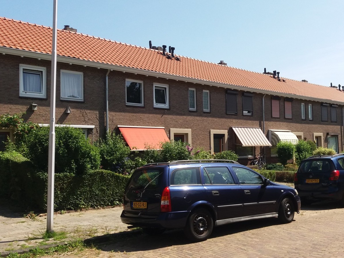 Street showing row of houses with awnings and shutters